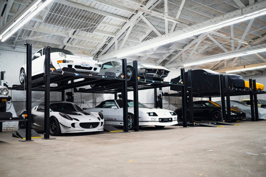 4 Post Lift Buying Guide: 10 Smart Questions for a Safer, More Space-Saving Choice 4 post lift buying guide. 4 post car lift in a home garage used for vehicle storage and parking space optimization