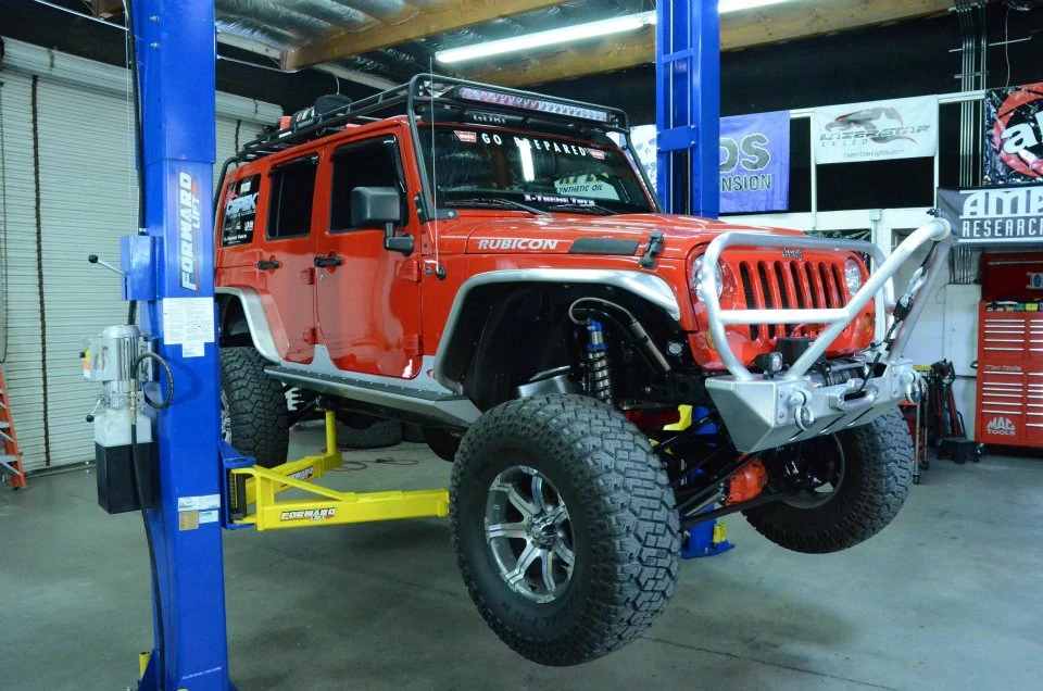 2 Post Lift Buying Guide: 9 Essential Questions to Answer Before You Buy jeep on forward two post lift. 2 post lift buying guide.