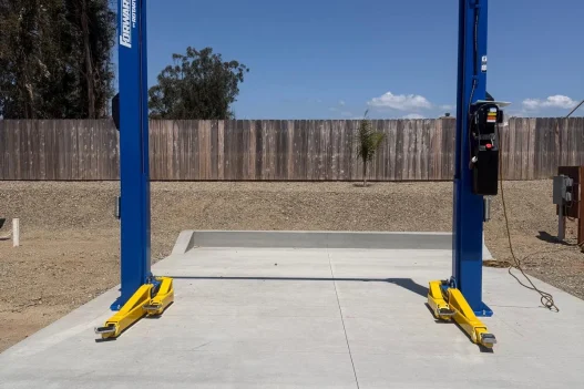 Forward Lift two-post automotive lift installed outdoors on concrete service pad