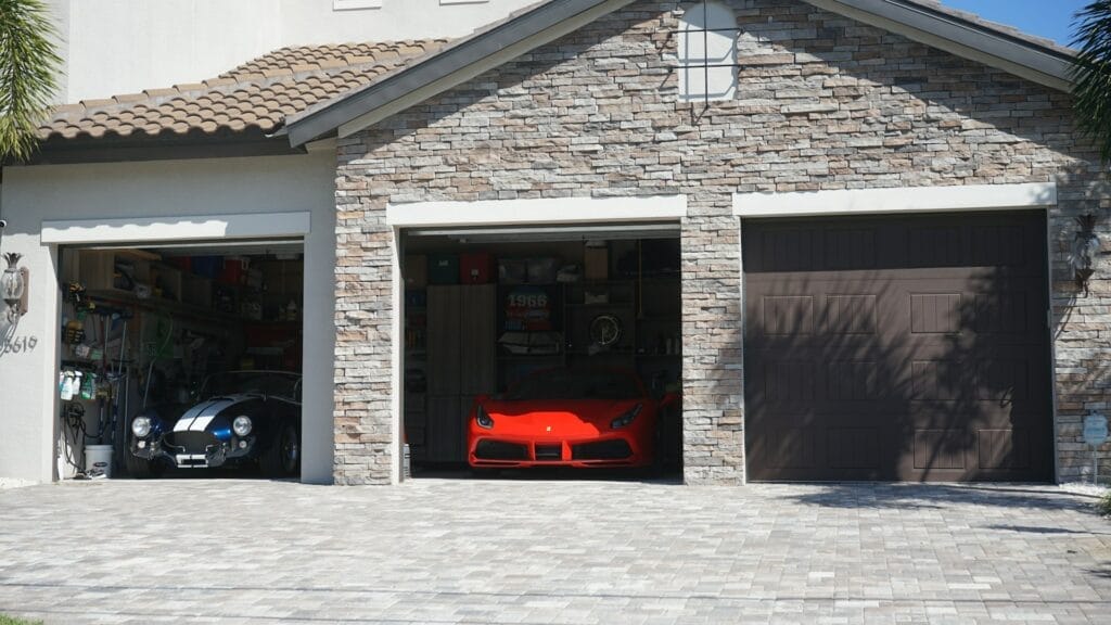 garage car lifts. Garage with a red porsche and blue corvette.